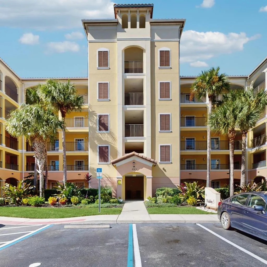 Photograph of Modern Orlando condo with pool, balcony views, and Disney shuttle
