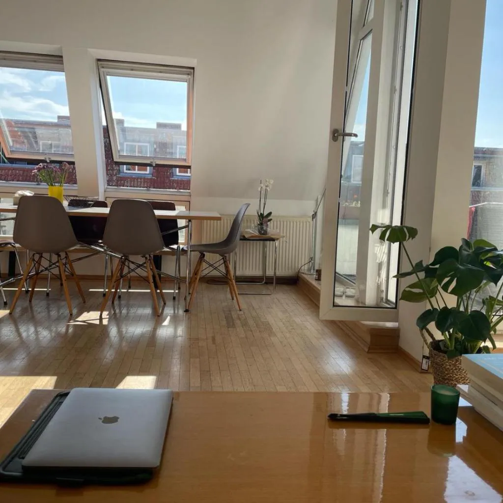 Photograph of bright rooftop loft with river view