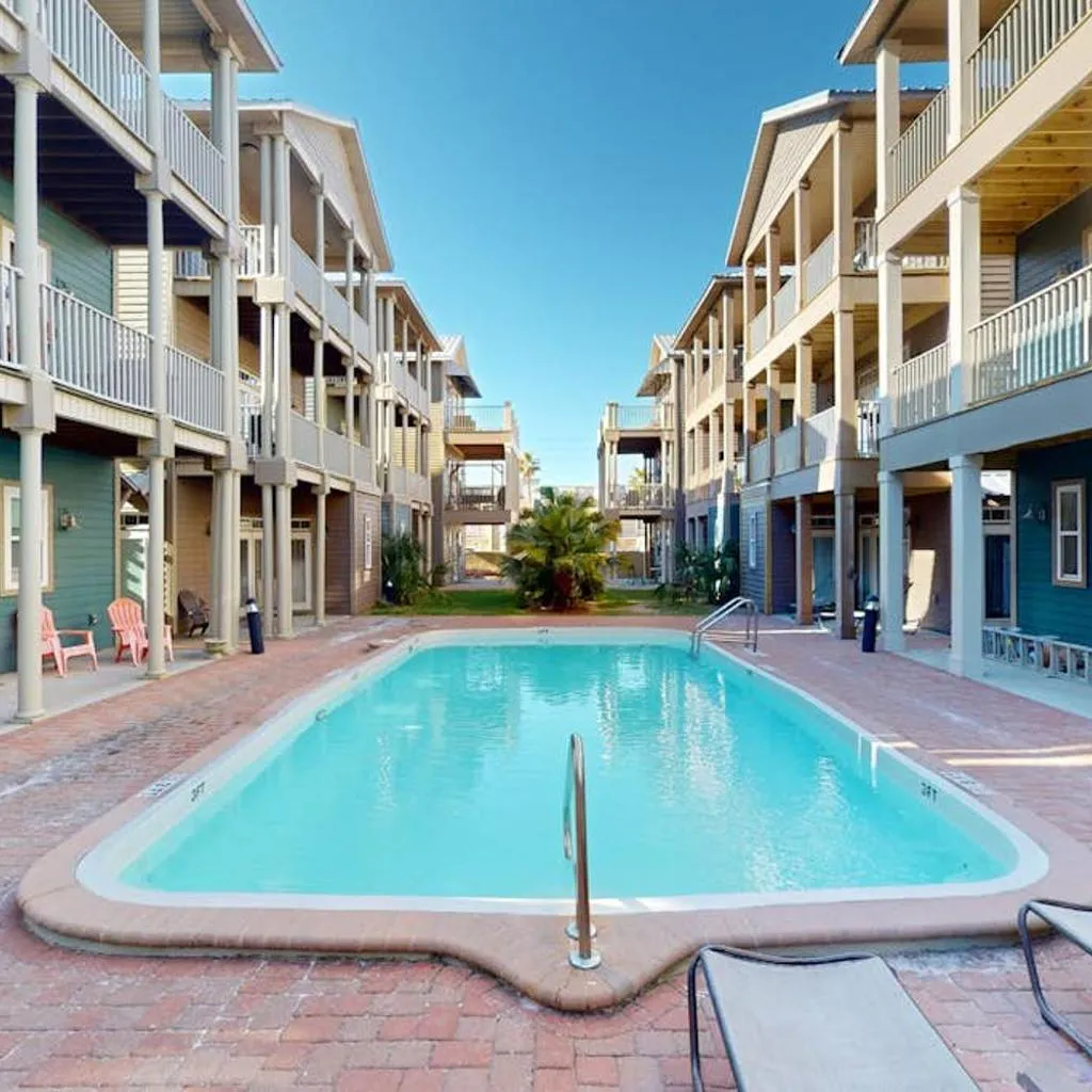 Photograph of 3-story dog-friendly home with pool & balcony - walk to beach
