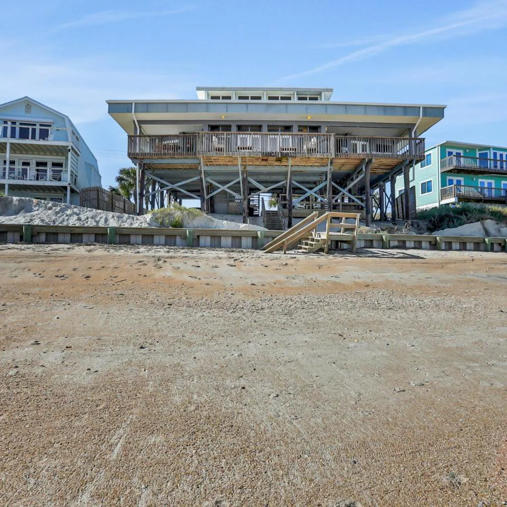 Photograph of Gorgeous beachfront home with inviting deck & patio, hammock, amazing views