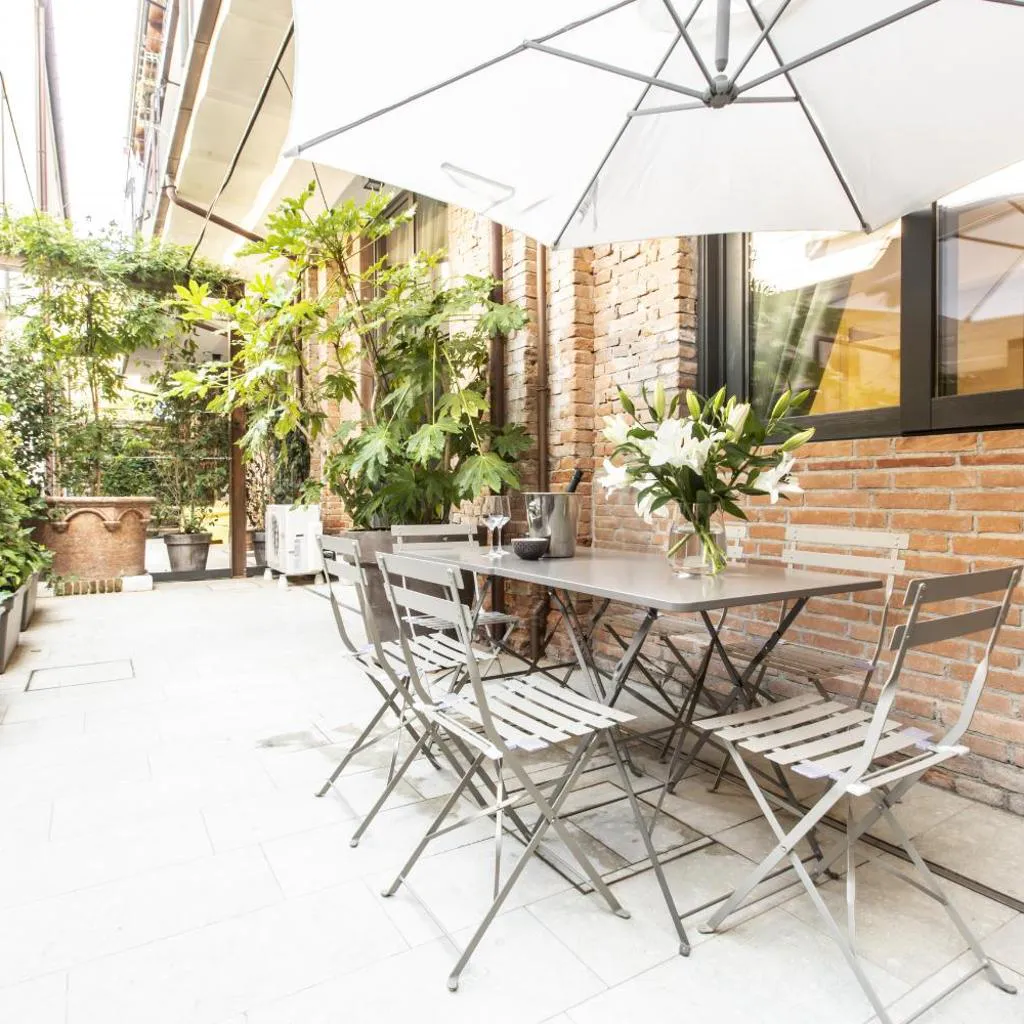 Photograph of Elegant Fornasa Vecia, canal view with a beautiful garden R&R