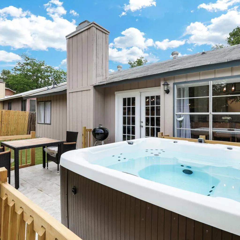 Photograph of Modern Paradise Hot Tub Game Room Swing Set BBQ