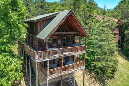 Photograph of Dreamy Forest Home, 2 Decks, Hot Tub, Outdoor Pool - 10 Mins to Broadway, Perfect for Groups, 24 Hour Hospitality, Sleep 10 with Wraparound Deck, Scenic Views & Access to Resort Pool, Near The Parkway, Tanger Outlets & Dollywood