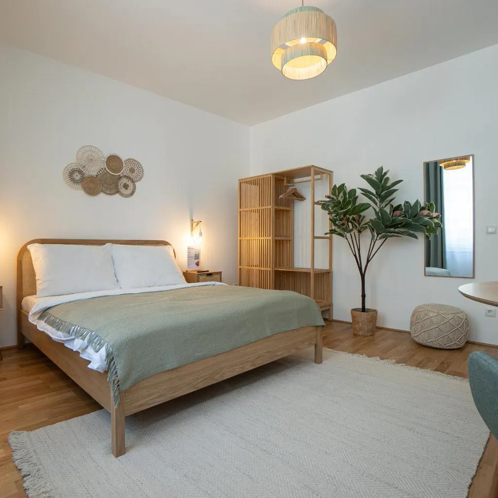 Photograph of Bright Modern Studio in Center with a Queen Bed